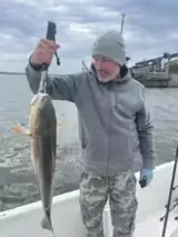 Photo attached to Brad’s review: angler holding a fish aboard the boat